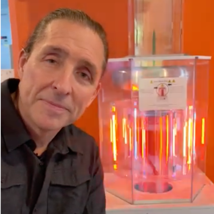 Dave Asprey Standing In Front of the Magical Lights of the BioCharger