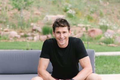 Ben Greenfield Sitting in Nature and Smiling