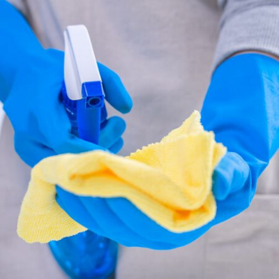 Hands Spraying Cleaner into a Microfiber Cloth