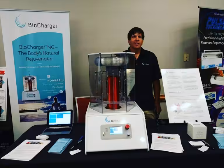 Jim Girard Standing Behind the BioCharger NG Device