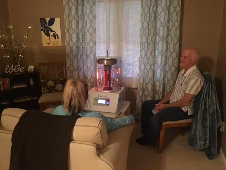 Happy Man and Woman Sitting Around Activated BioCharger
