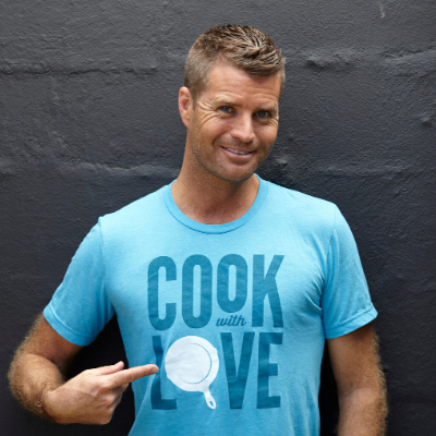 Pete Evans Showing his T-Shirt and Smiling