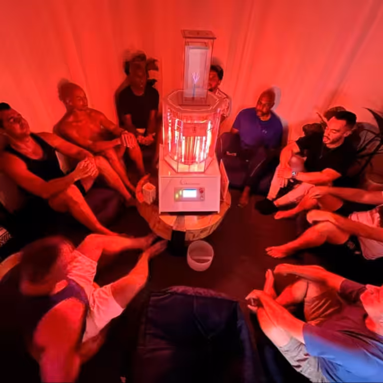A Group Of People Sitting on the Ground Enjoying a BioCharger Session