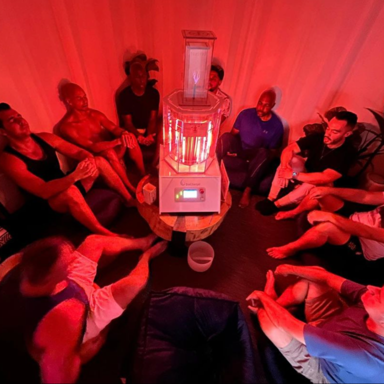A group of people sitting on the ground enjoying a BioCharger session