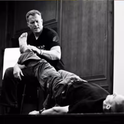 Dr. Perry Nickelston Helping Patient with His Leg