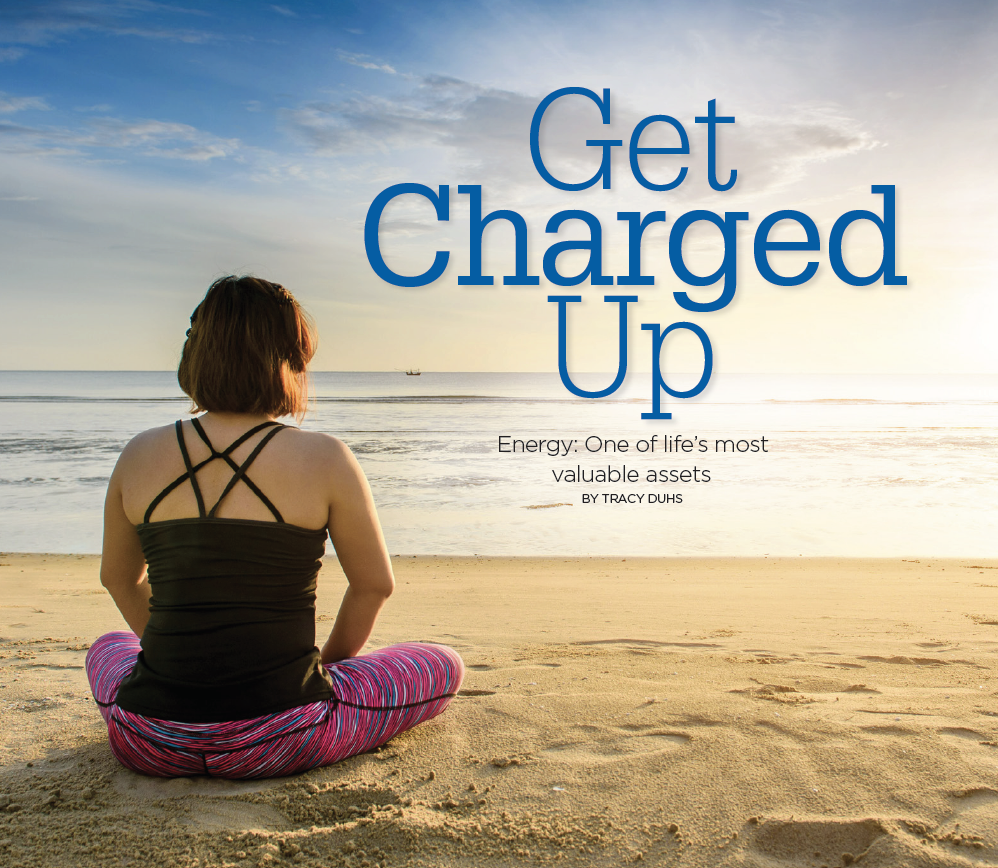 Get Charged Up Text Next to Female in Yoga Position Relaxing on the beach