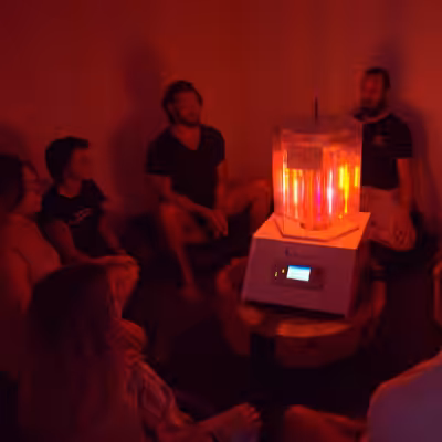 Group of People Sitting Around Working BioCharger Device