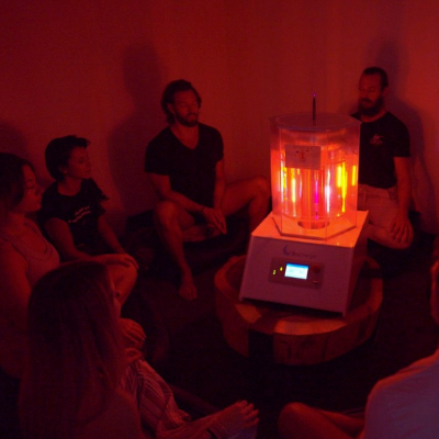 Group of People Sitting Around Working BioCharger Device