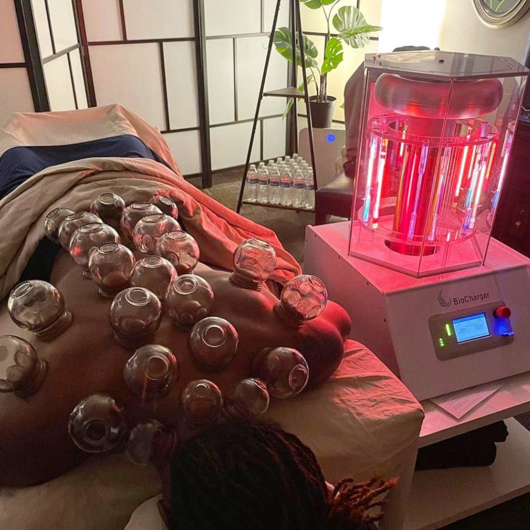 Woman Lying In Cupping Therapy Next to the Working BioCharger Device