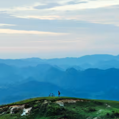 Landscape Mountains View With Man and His Bicycle