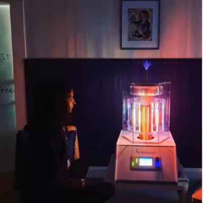 Woman Sitting and Looking at Working BioCharger Device