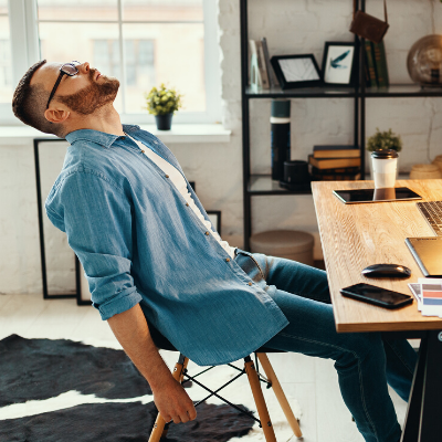 Exhausted Man Sitting at Working Desk