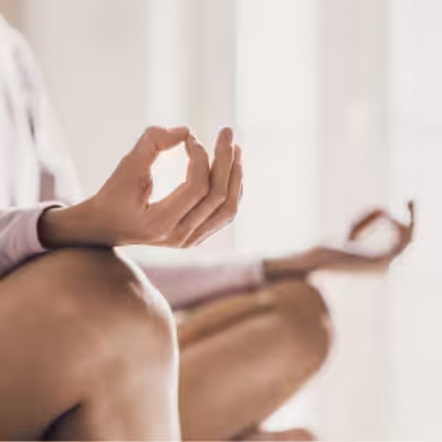 Close Up of a Woman Sitting in a Lotus Position With Yoga Hand Gesture