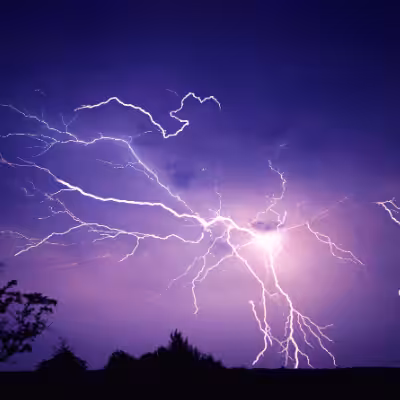 Multiple Lightning Strokes on a Purple Night Sky