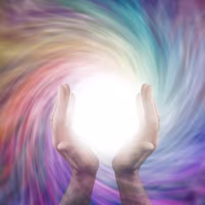 Two Hands Holding a White Light Orb against a Multicolored Flowing Magnetic Field