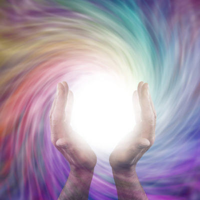 Two Hands Holding a White Light Orb against a Multicolored Flowing Magnetic Field