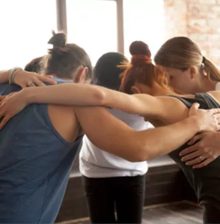 Group of Man and Women Hugging in the Gym