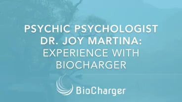 Psychic Psychologist Dr. Joy Martina Expirience with BioCharger Text on a Blue Background with a Tree