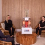 Three women sitting next to a working Biocharger