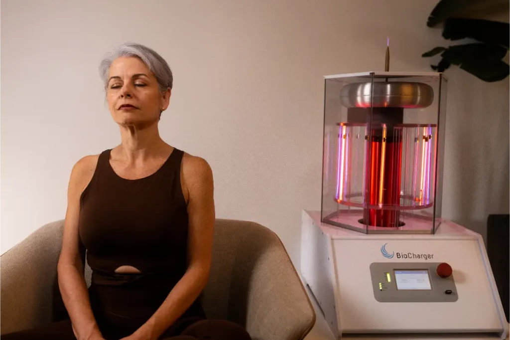 A woman with short grey hair relaxing next to a bio charger.