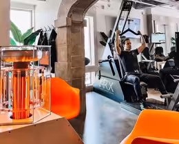 A bio charger next to a man who is working out.