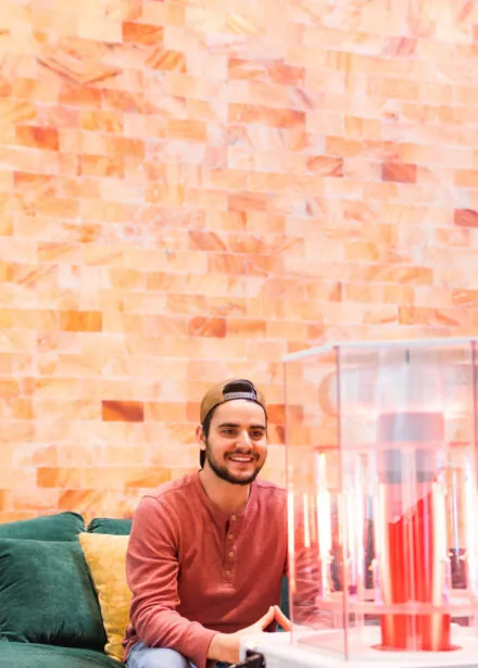 Man in baseball cap smiling.